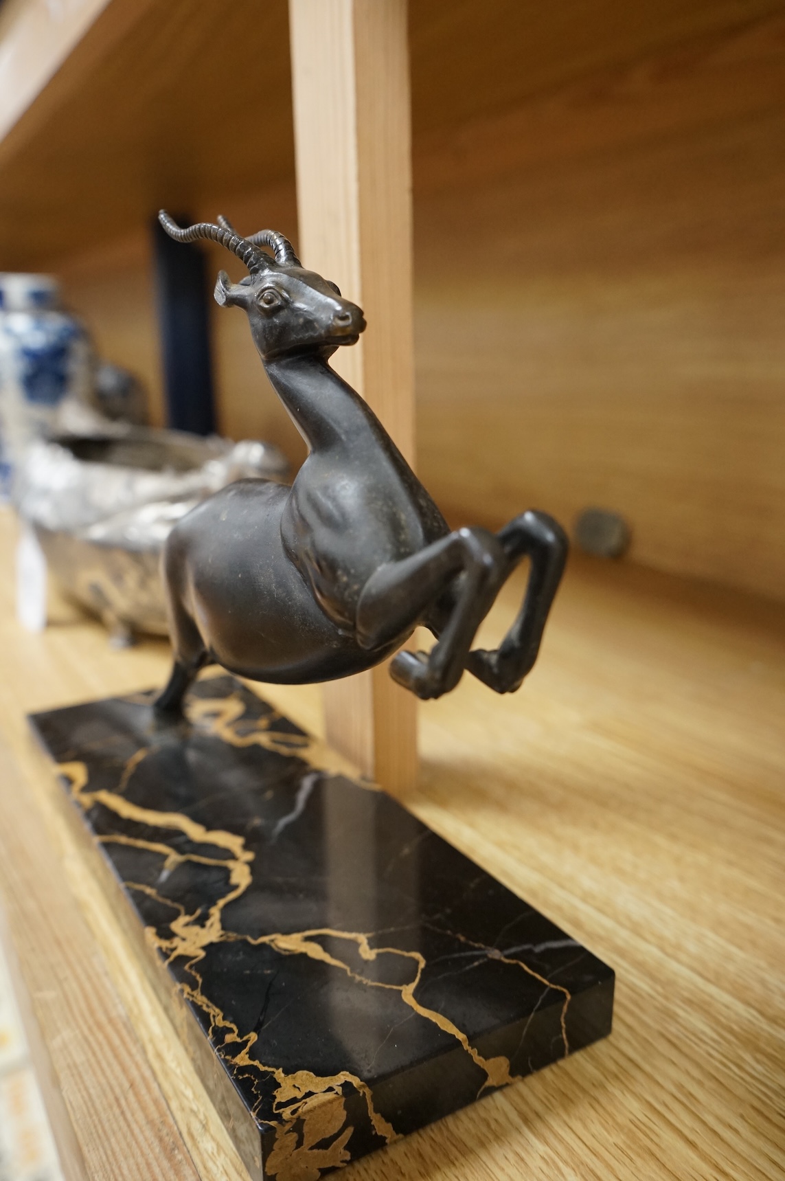 An Art Deco spelter study of a leaping gazelle, 27cm wide